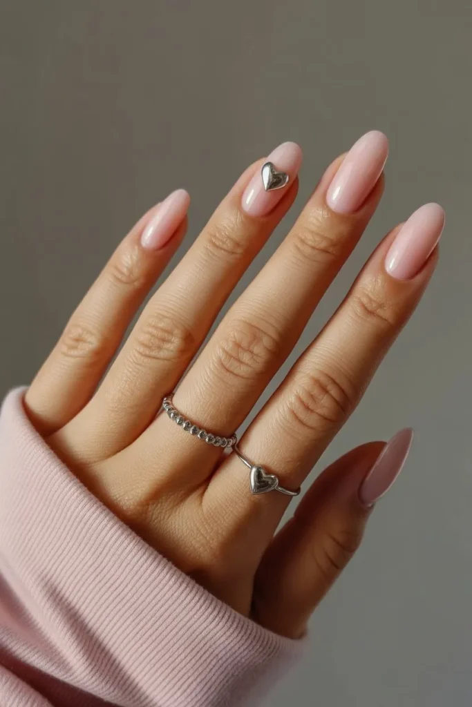 Short pink chrome nails with tiny heart