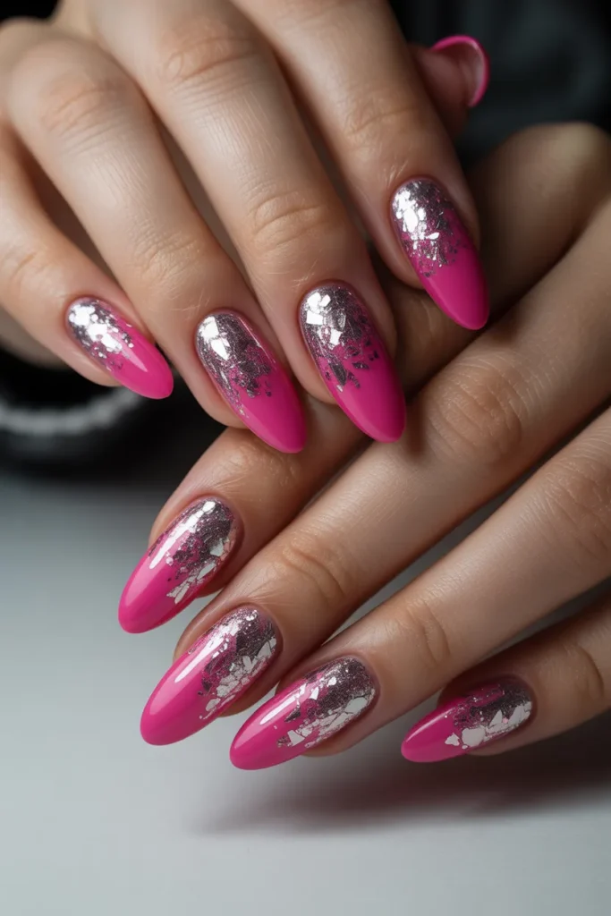 Bright hot pink nails fading into chunky silver glitter ombre on long almond nails