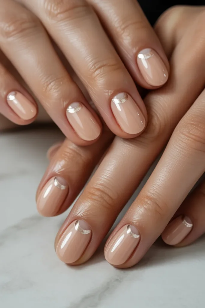 Nude nails with subtle half-moon design