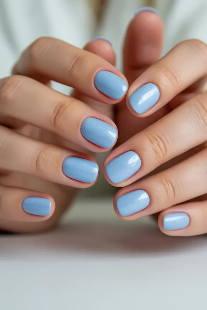 Soft pastel blue nails, short rounded shape