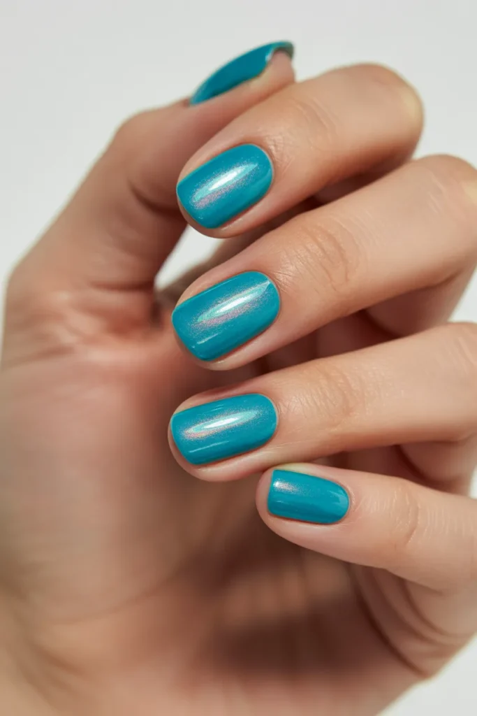 Bright turquoise nails with glossy finish and subtle shimmer