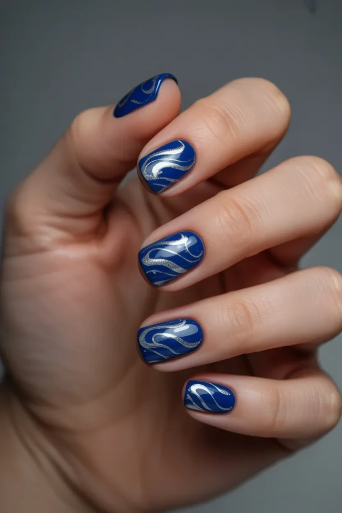 Dark blue nails with swirl patterns