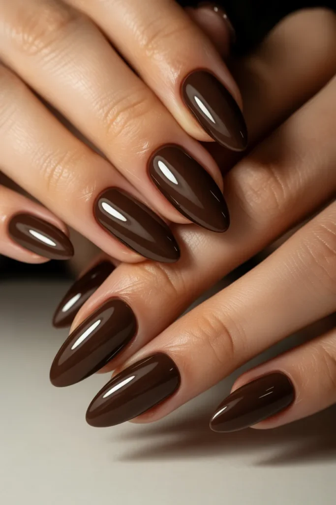 Deep chocolate brown almond-shaped nails
