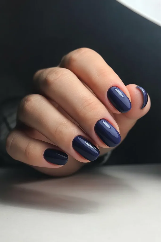 Glossy dark navy blue nails, short oval shape