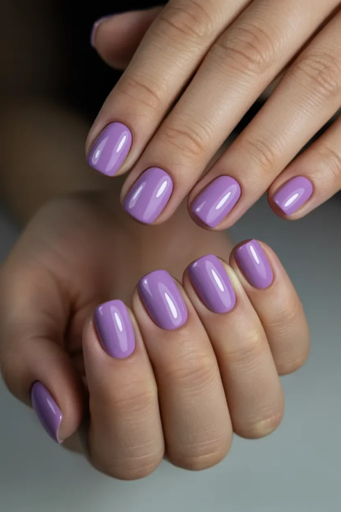 Glossy lilac short square nails with soft lighting