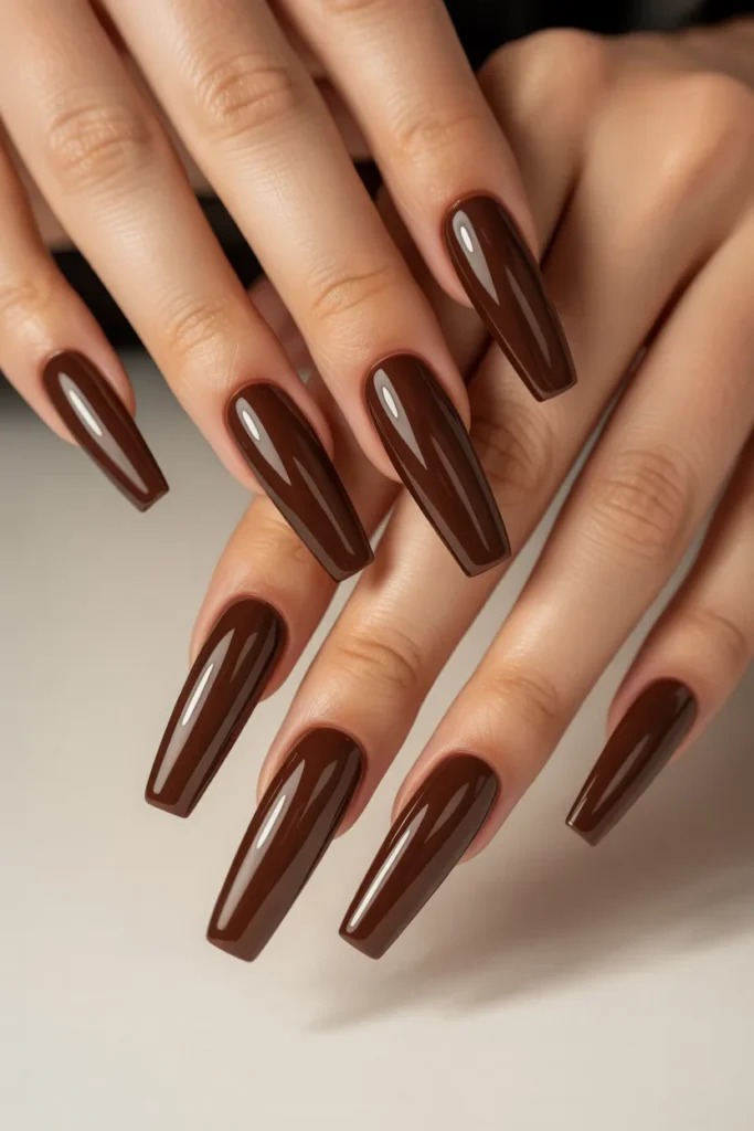 Long coffin-shaped nails in glossy chocolate brown