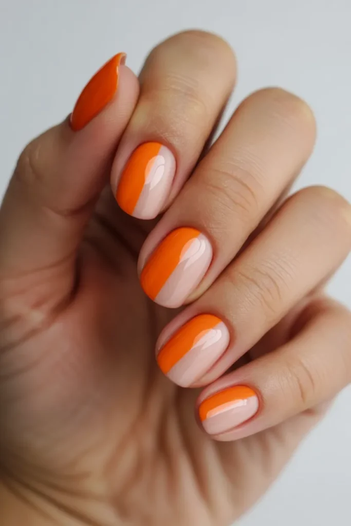 Nails split into orange and nude halves