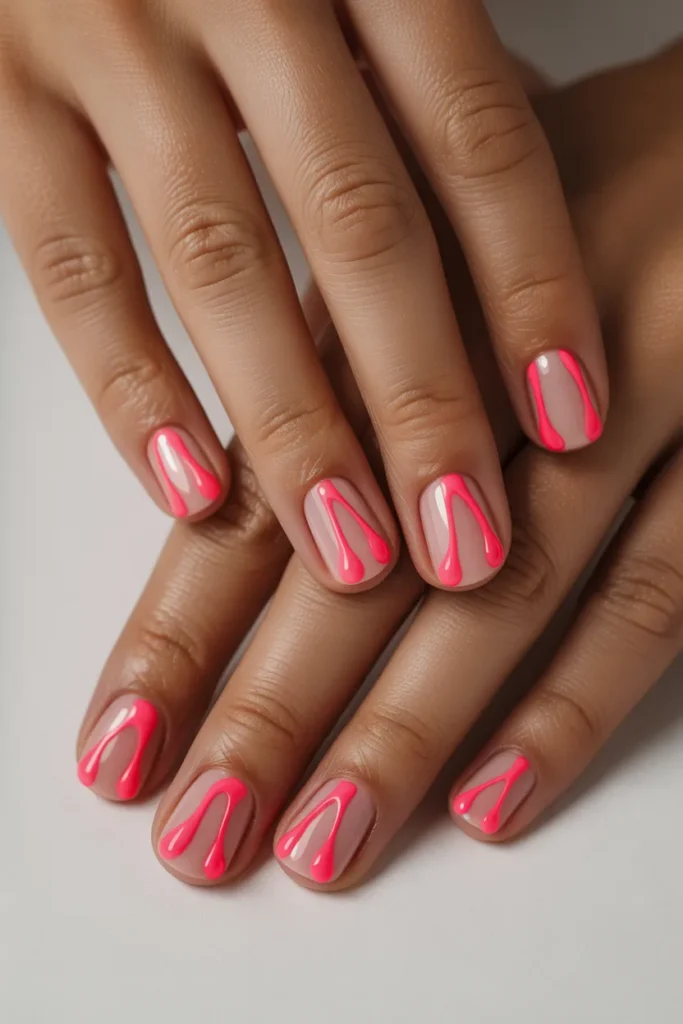 Neon pink drip effect over nude base nails