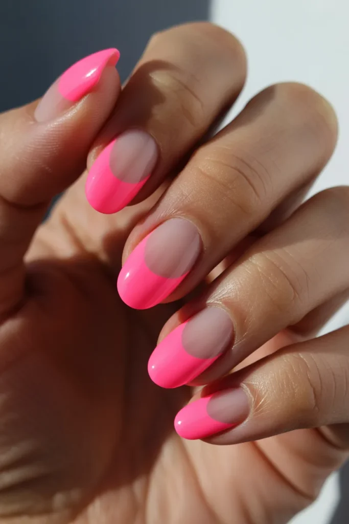 Neon pink nails with negative space half-moon design