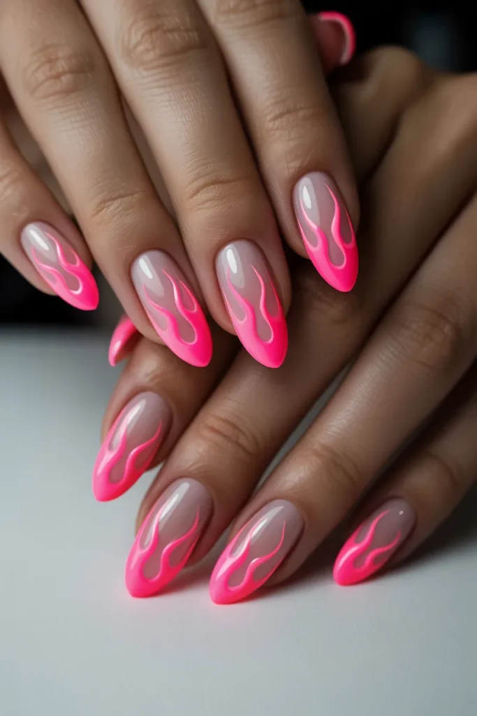 Nude base nails with neon pink flame art on long nails