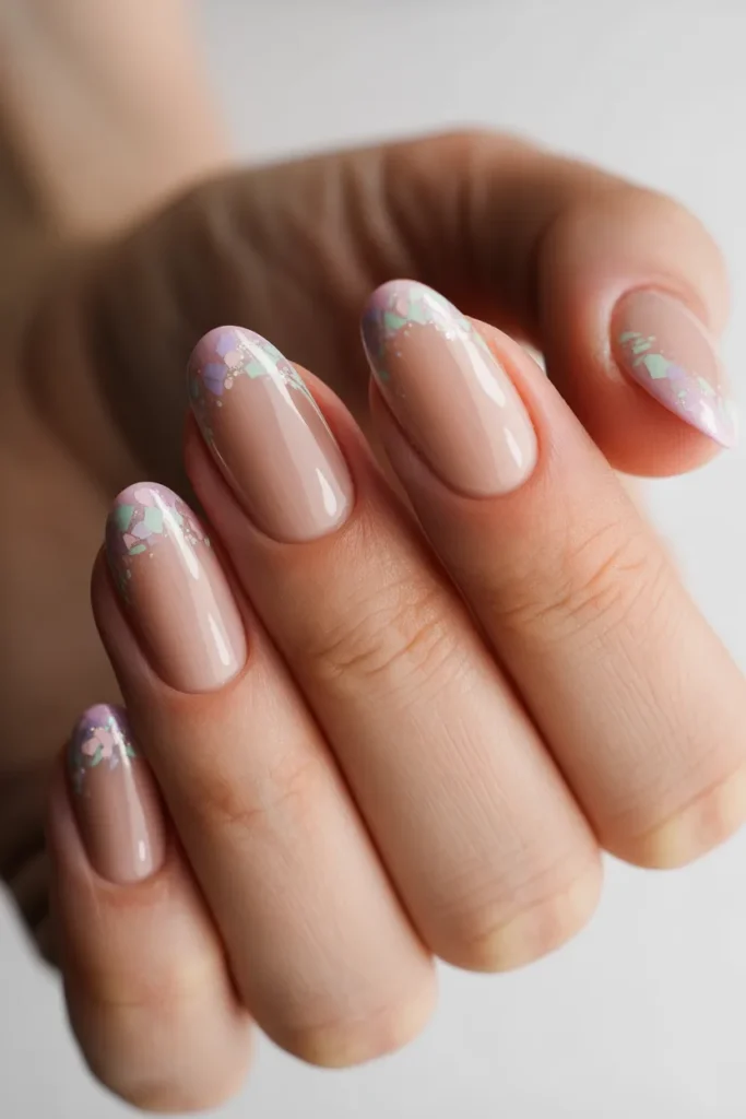 Nude nails with pastel glitter tips
