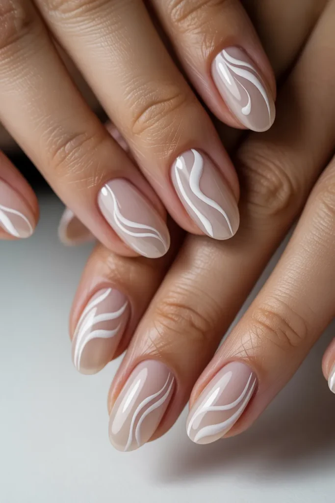  Nude oval nails with white swirl nail art