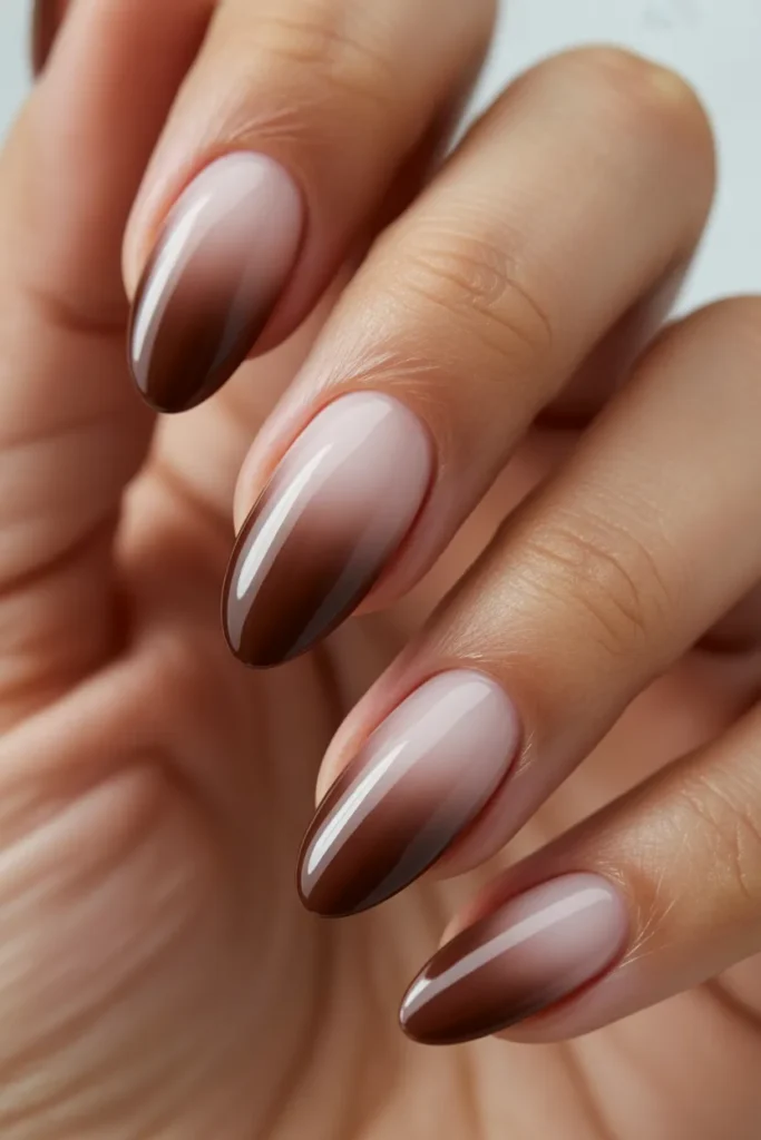 Ombre nails blending light beige to deep chocolate brown, almond shape