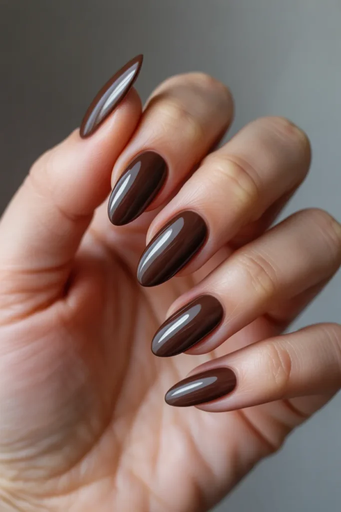 perfectly manicured glossy chocolate brown nails, almond shape