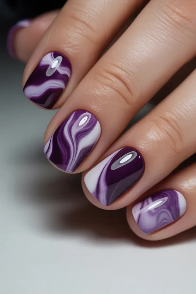 Purple and white marble swirl nail art, glossy texture