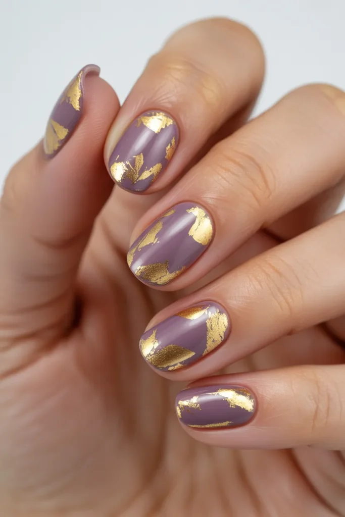 Purple milk nails with gold foil flakes