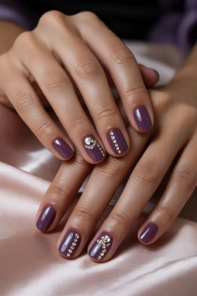 Purple nails with small rhinestones