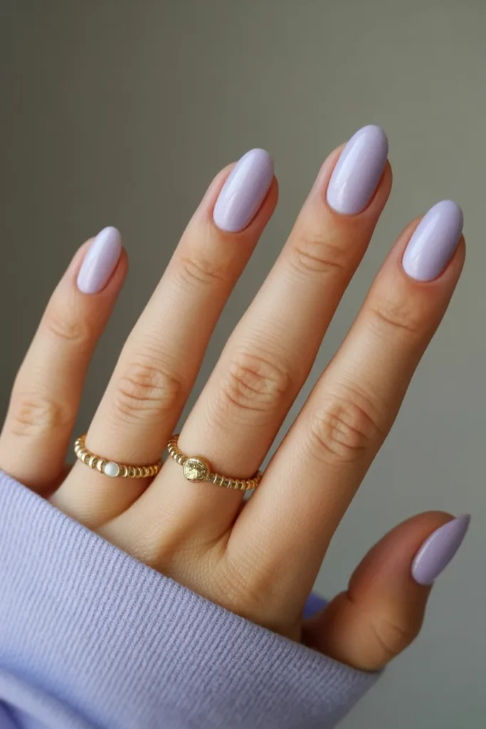 Soft pastel lavender nails with a glossy milky finish