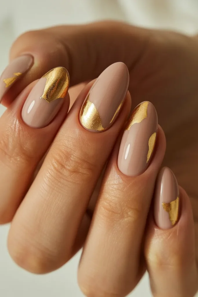 nude almond nails with gold foil accents